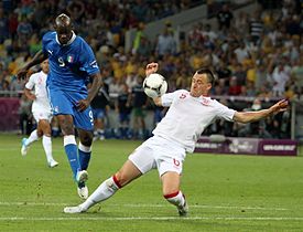 Terry (right) attempts to block a shot from Italy's Mario Balotelli at UEFA Euro 2012.