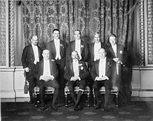 1926 Imperial Conference: George V and the prime ministers of the Commonwealth. Clockwise from centre front: George V, Baldwin (United Kingdom), Monroe (Newfoundland), Coates (New Zealand), Bruce (Australia), Hertzog (South Africa), Cosgrave (Irish Free State), King (Canada).