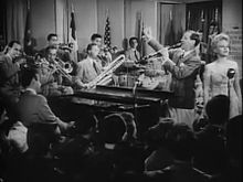 Goodman with his band and singer, Peggy Lee, in the film Stage Door Canteen (1943)