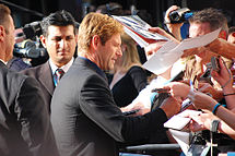 Eckhart signing autographs for fans during promotion of The Dark Knight in 2008.