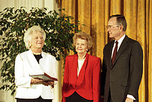 Betty Ford is awarded the nation's highest civilian honor, the Presidential Medal of Freedom, by President George H. W. Bush, 1991. First Lady Barbara Bush holds the medal.