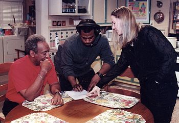 Cosby volunteered his time and talent to promote causes such as the Partnership for a Drug Free America's campaign to de-glamorize drugs, during the 1990s and beyond, writing the script and appearing in a PSA to discourage the use of illegal drugs by young people. Photo: going over the script with Partnership executive Ginna Marston (right) and a production assistant at Cosby's studio in Astoria, Queens, in the 1990s. Photo by Bobby Sheehan.