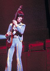 Wyman, on bass during the Rolling Stones' tour in 1975 — holding the instrument vertically is his trademark.