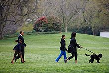 The Obamas walking with Bo
