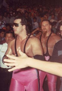 Hart (left) with Jim Neidhart behind him as The Hart Foundation.
