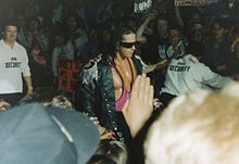 For his entrances, Hart often wore a leather jacket with shoulder tassels (epaulets), Mylar wrap-around (originally silver, later pink) sunglasses and bright pink attire.