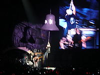 Brian Johnson hangs on to a bell while performing the song "Hells Bells".
