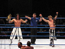 Paul London (far left) and Brian Kendrick (far right) as WWE Tag Team Champions.