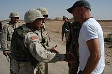 Willis meets with Brigadier General Albert Bryant, Jr and deployed soldiers from the 4th Infantry Division, in Tikrit, Iraq, during his 2003 USO tour.