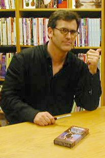 Campbell signing a VHS copy of The Evil Dead at a fan meet-and-greet