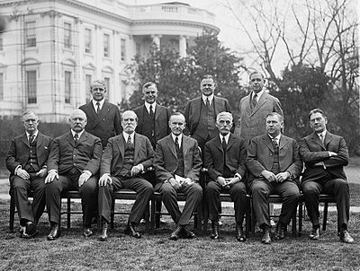 Coolidge's cabinet in 1924, outside the White House Front row, left to right: Harry Stewart New, John W. Weeks, Charles Evans Hughes, Coolidge, Andrew Mellon, Harlan F. Stone, Curtis D. Wilbur Back row, left to right, James J. Davis, Henry C. Wallace, Herbert Hoover, Hubert Work