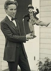 By 1916, Chaplin was a global phenomenon. Here he shows off some of his merchandise, c. 1918