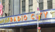 Sheen's "My Violent Torpedo of Truth/Defeat is Not An Option" tour on the marquee of Radio City Music Hall in New York City.