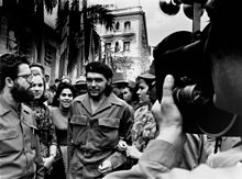 Guevara in 1960, walking through the streets of Havana with his wife Aleida March (right)