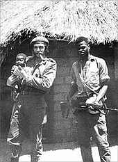 37-year-old Guevara, holding an African baby and standing with a fellow Afro-Cuban soldier in the Congo Crisis, 1965.