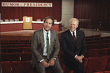 Gerald Ford and Chevy Chase sit before the Conference on Humor and the Presidency held at the Gerald R. Ford Museum in 1986.