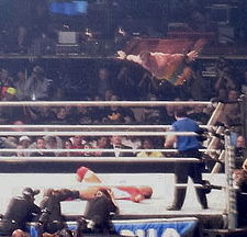 Chris Benoit performing a diving headbutt on MVP at WrestleMania 23.