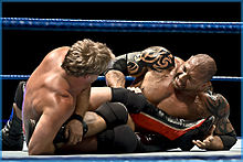 Chris Jericho applying a submission hold to Batista.