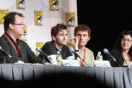 Tennant with Doctor Who showrunner Russell T Davies (left), regular director Euros Lyn (centre right), and executive producer Julie Gardner (right) at Comic-Con in July 2009
