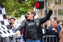 David Hasselhoff waving the checkered flag at the 2008 Gumball 3000.